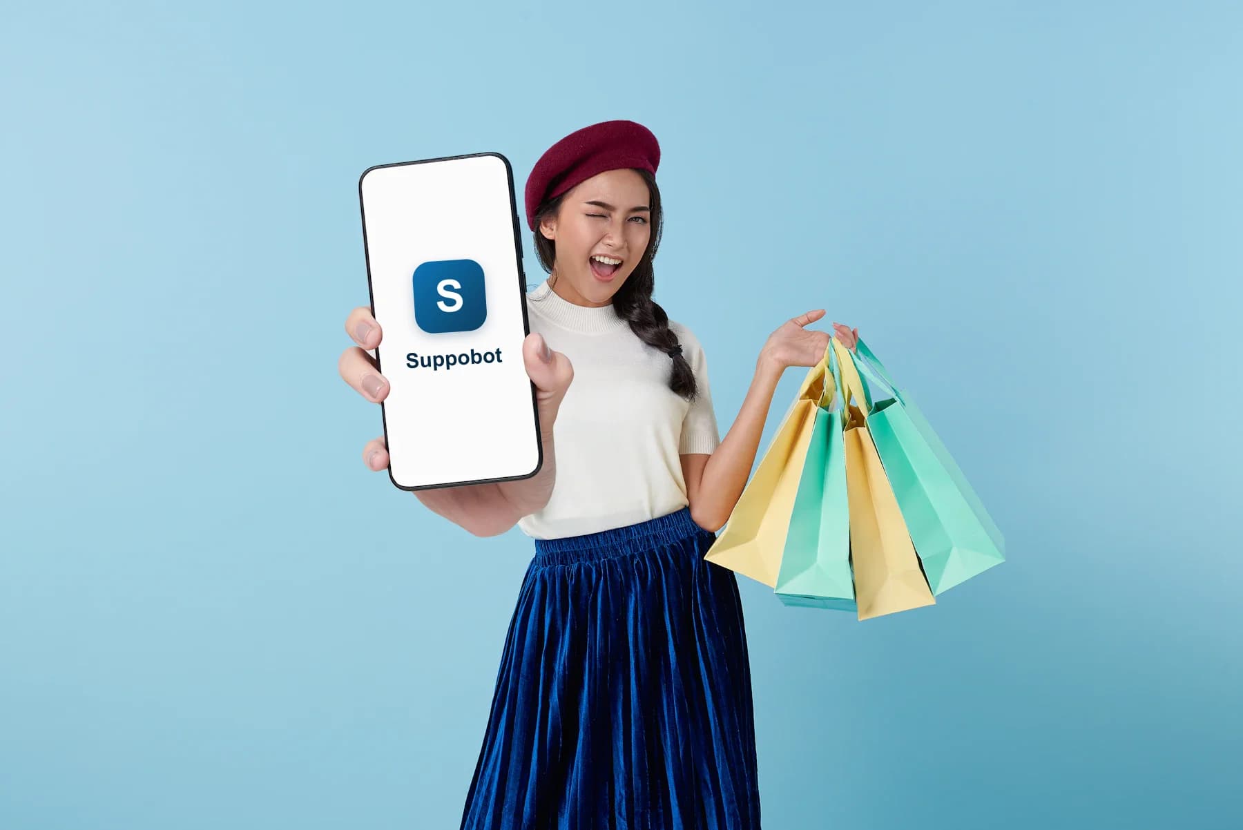 A happy shopper with her phone and shopping bags